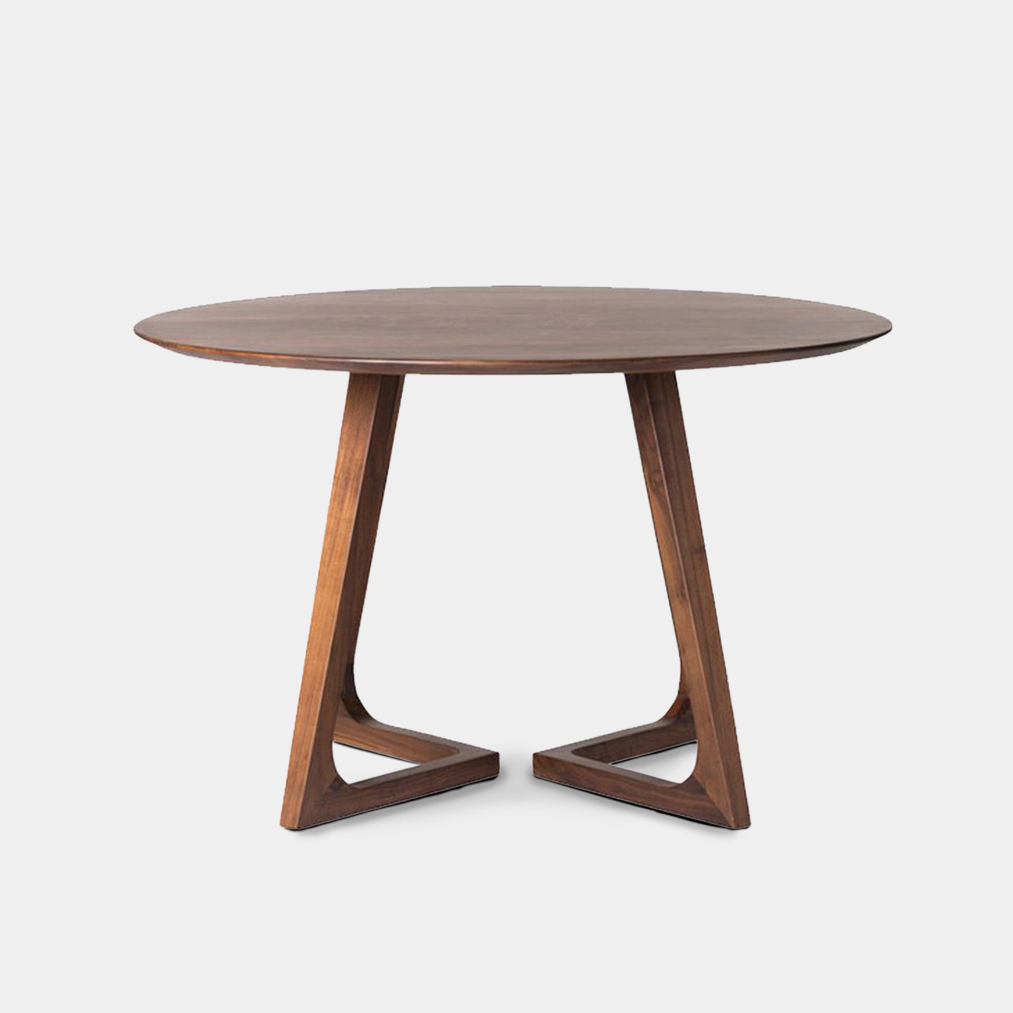 Thonburi round dining table with knife-edge profile and geometric open-base pedestal, handcrafted from 100% reclaimed old teak in Chiang Mai, Thailand.