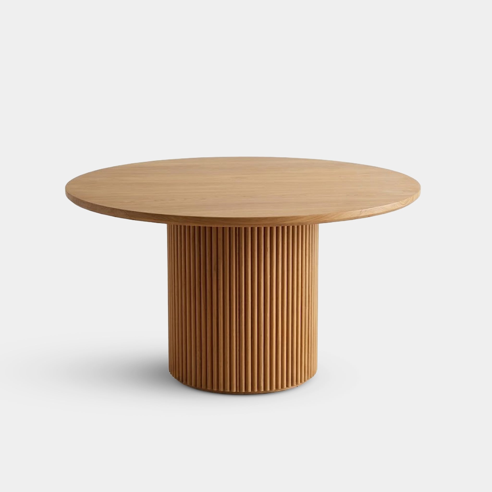 Lanna round dining table with fluted pedestal base, handcrafted from 100% reclaimed old teak in Chiang Mai, Thailand.